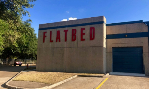 Image of the Flatbed sign on the side of the building.