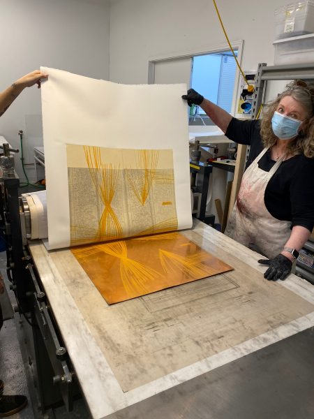 Katherine pulling a proof off a large intaglio plate