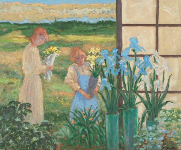 Two ladies standing in an open greenhouse