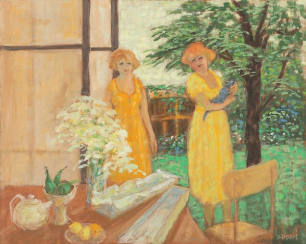 Two ladies standing behind a table, one with a cat