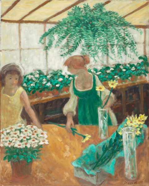 Two ladies standing in a greenhouse